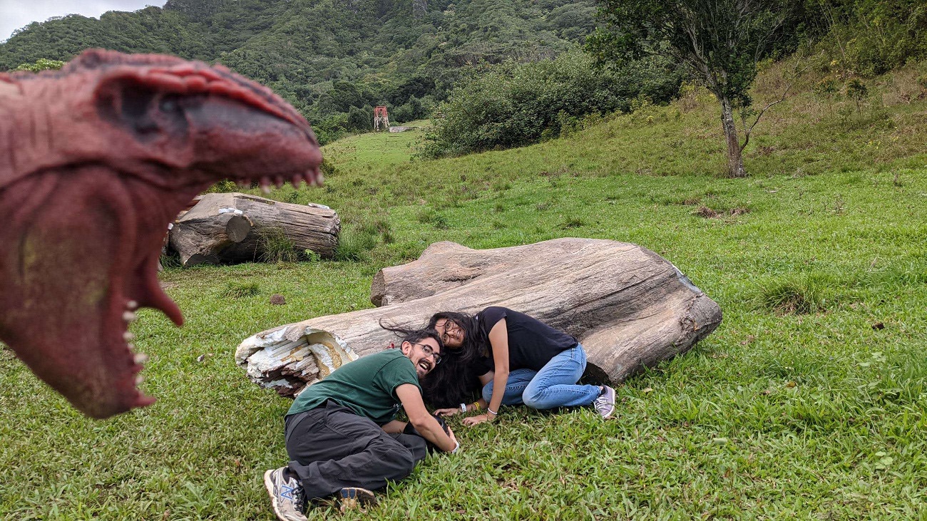Paul and Jessie hiding beneath a log at Kualoa Ranch
