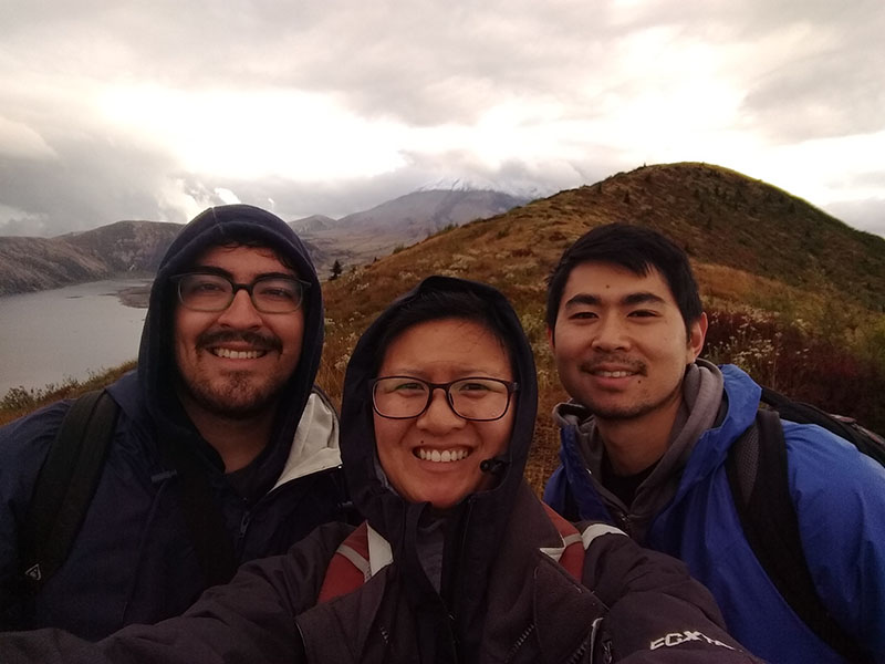 Paul, Jessie, and their friend Calder with Mount St. Helens behind them