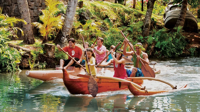 family paddling on the river at Polynesian Cultural Center