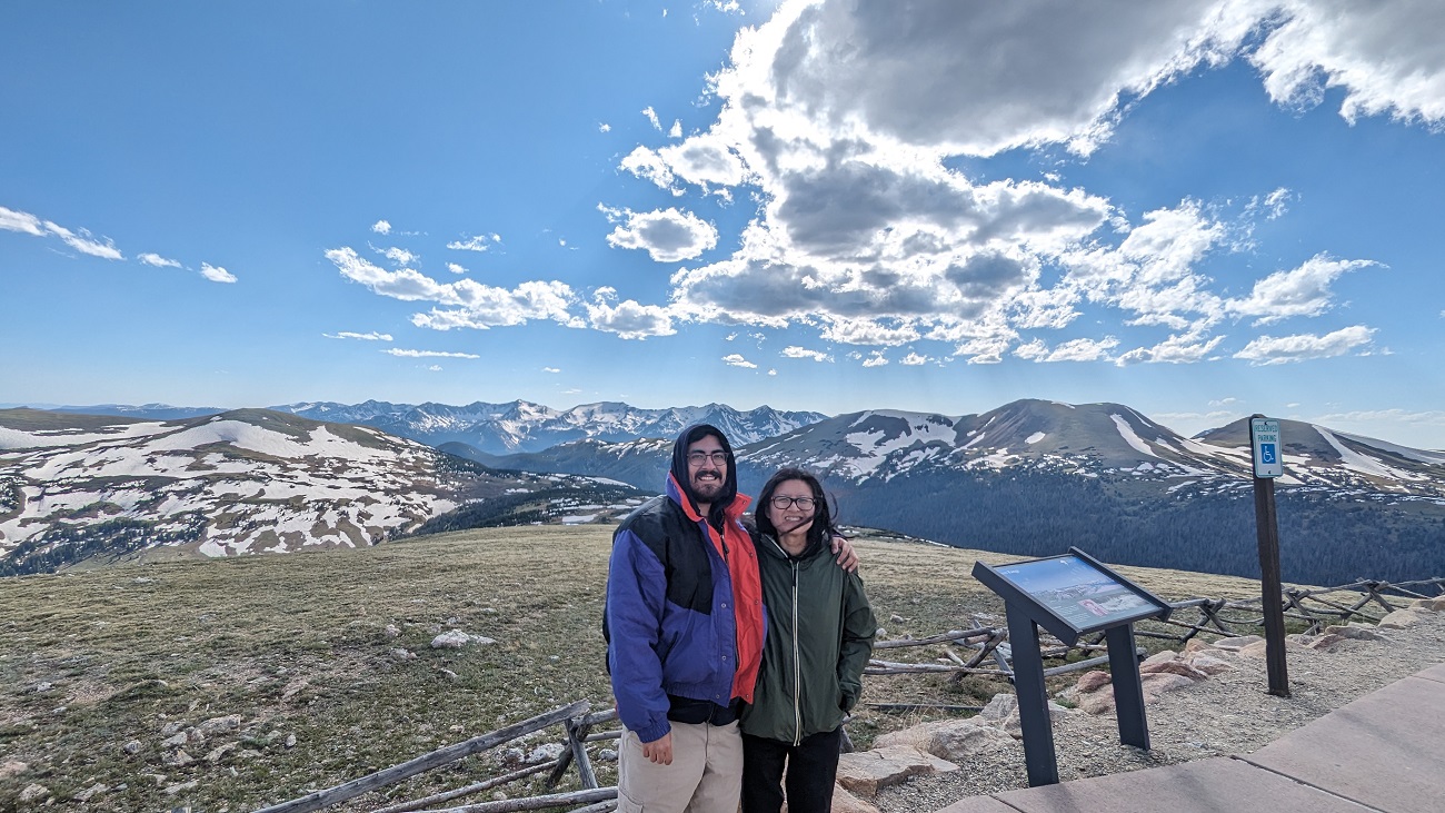 Paul and Jessie standing on a rock at Rocky Mountain National Park